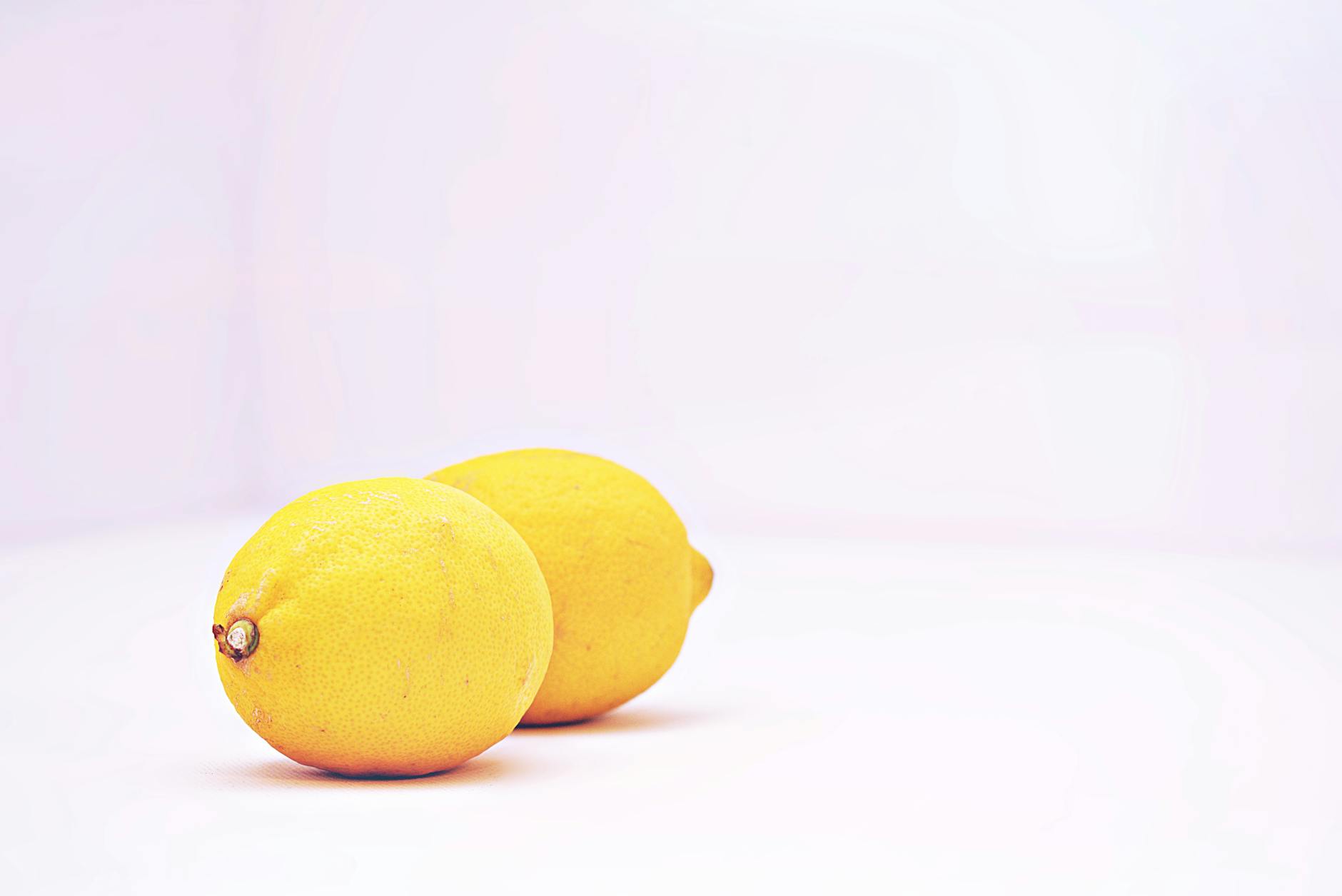 Hands holding pastel-colored silicone toys against a soft background