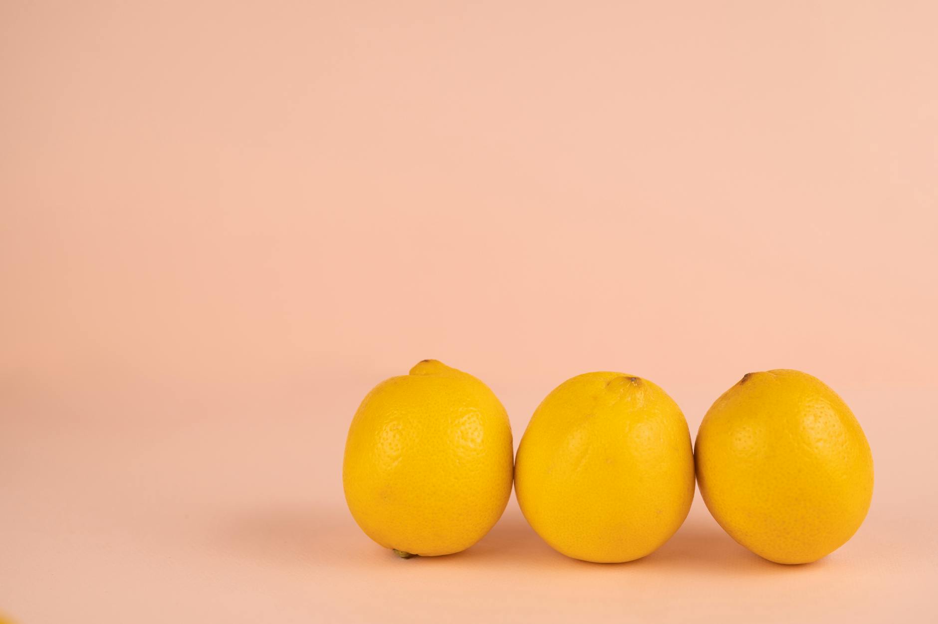 Bright ripe lemons arranged on a pastel background, symbolizing freshness and renewal